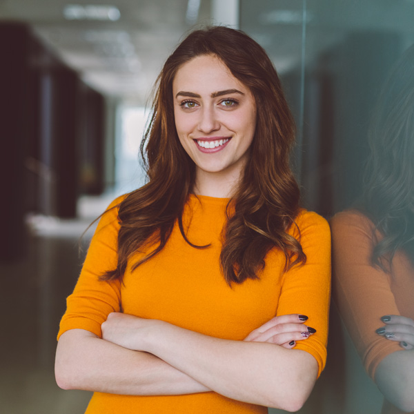 woman leaning against wall smiling